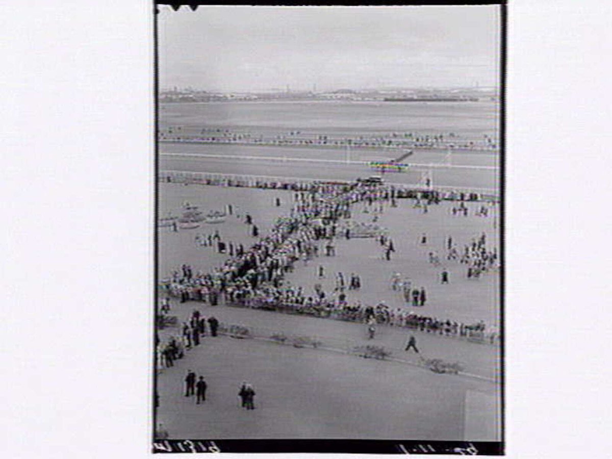 Bird's-eye view of Flemington Racecourse, showing horses on track in distance (1949)