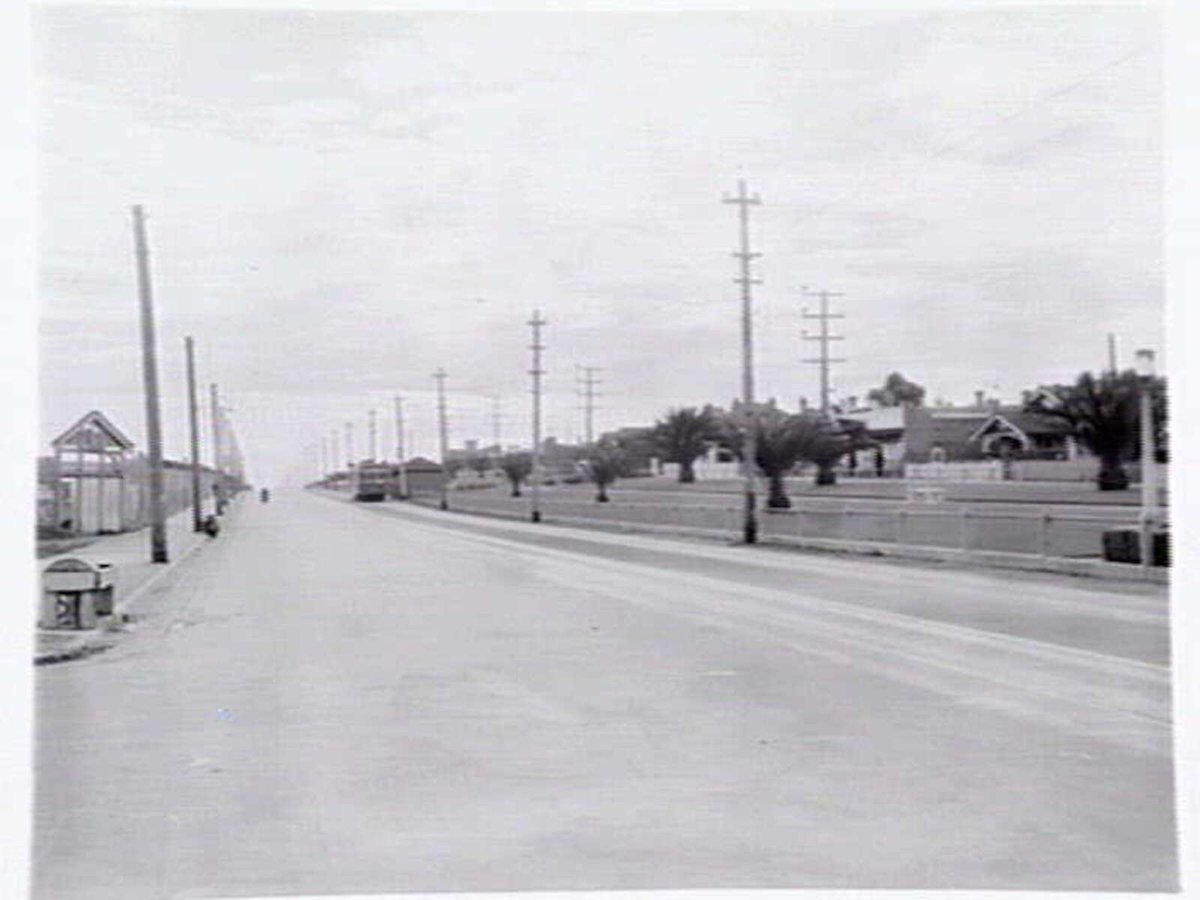 View of St. Georges Road Thornbury, looking north, showing a no. 9 tram and the old racecourse at left (c. 1941)