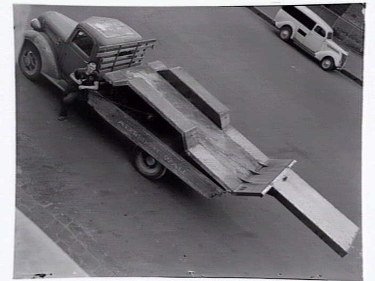 Looking down on a man standing beside a truck belonging to Alfred H. Wall, Window Frame Manufacturer, 8 Tinning Street, Brunswick (c. 1941)