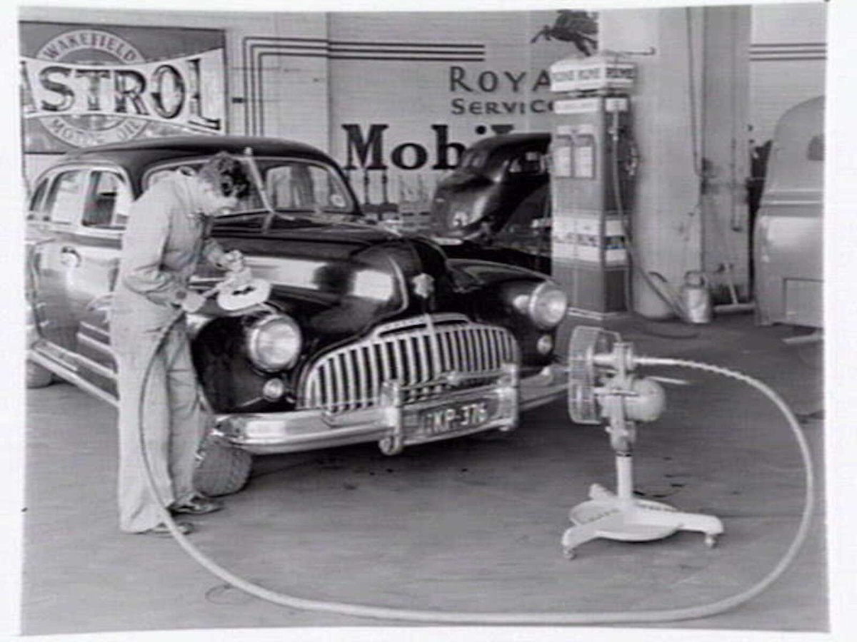 Buick being polished and buffed at Royal Park Service Garage, 411 Flemington Rd., North Melbourne, Parkville (1950)