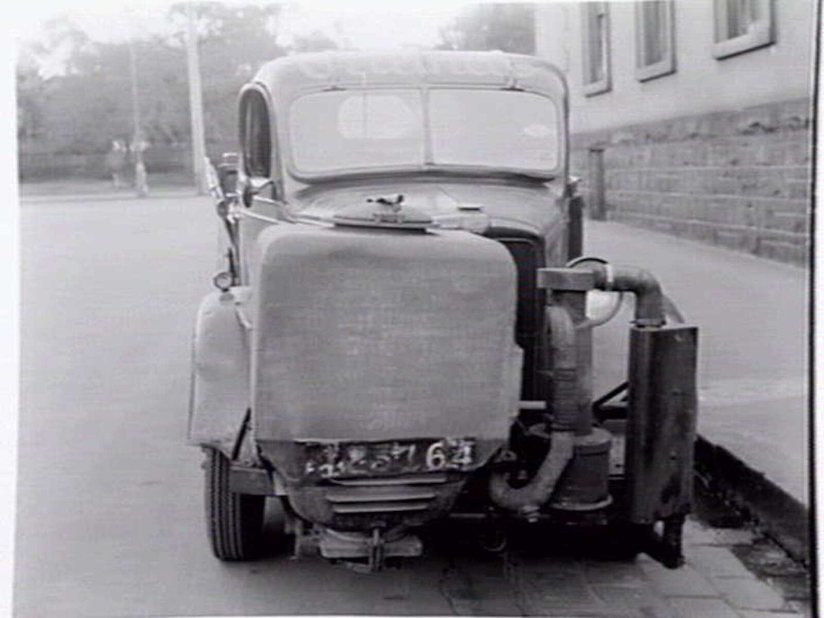 Truck belonging to G. Gramp and Sons Cellars, of 623 Collins Street, fitted with gas producer unit, Melbourne City (c. 1943)
