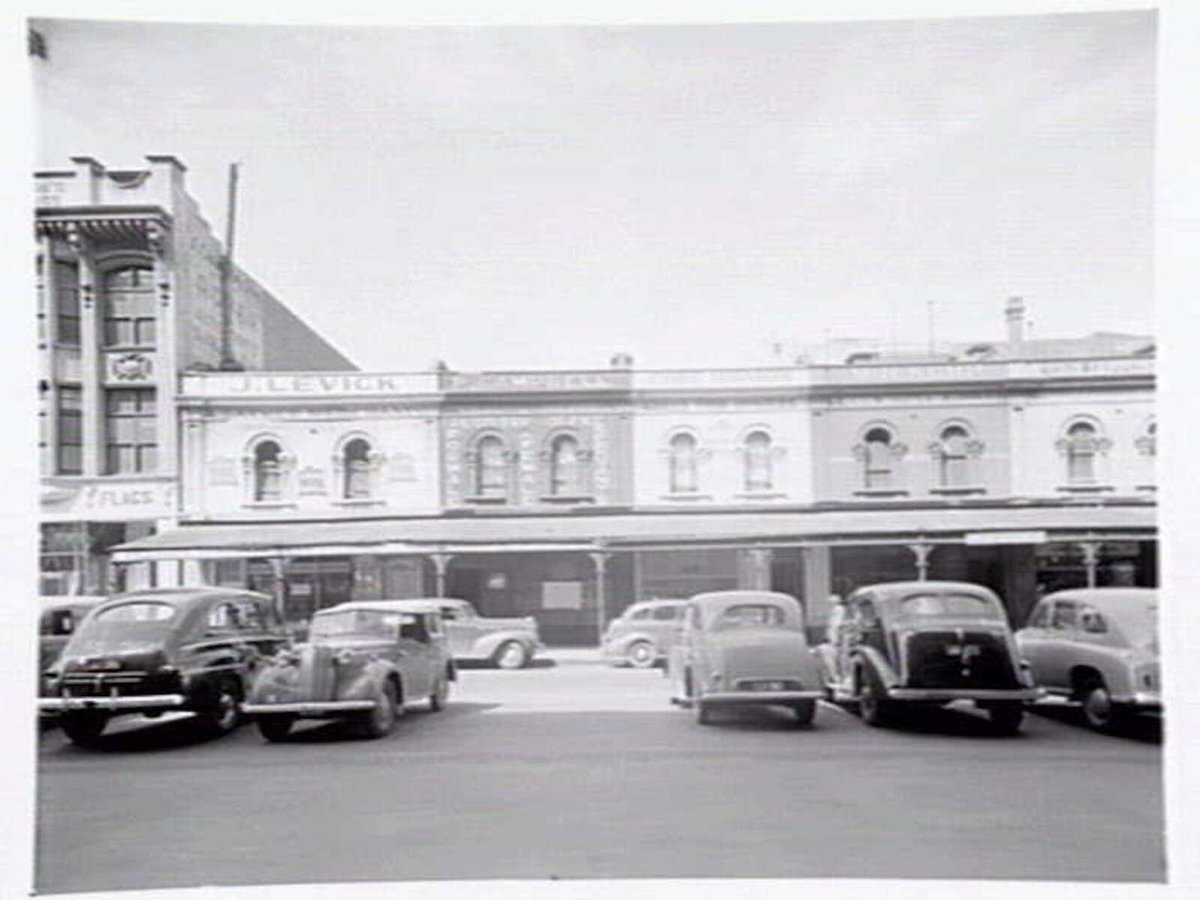 Shopping strip showing small and mixed businesses at 164-172 Queen Street, Melbourne, Melbourne City (1949)