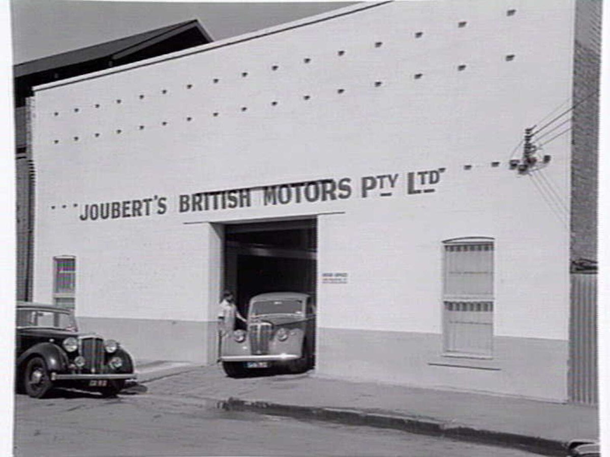 Joubert's British Motors P/L, Chessel St., South Melbourne, showing outside and mechanics at work inside (c. 1953)