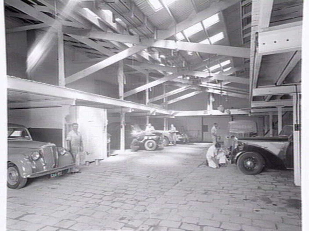 Joubert's British Motors P/L, Chessel St., South Melbourne, showing outside and mechanics at work inside (c. 1953)