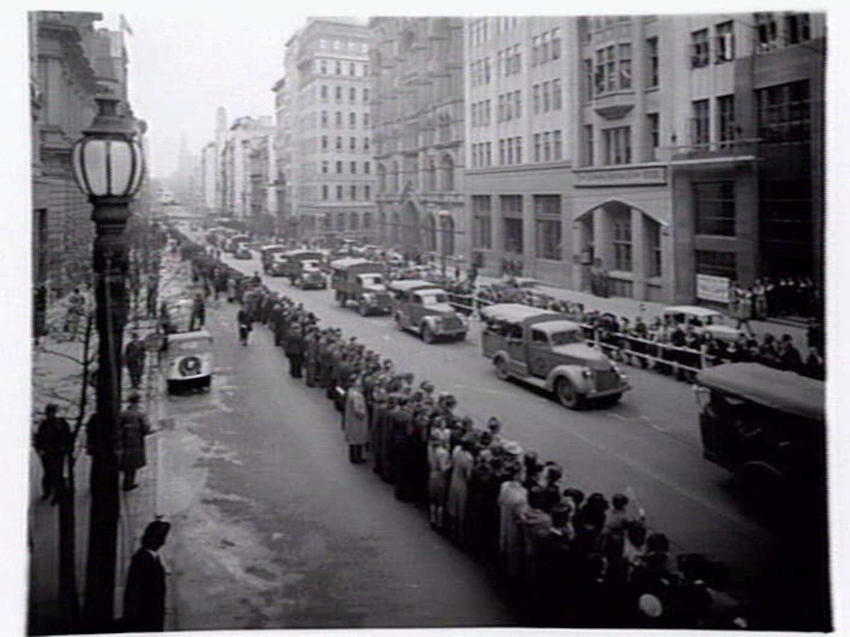 Military procession including tanks and trucks along Collins Street, Melbourne, Melbourne City (c. 1943)