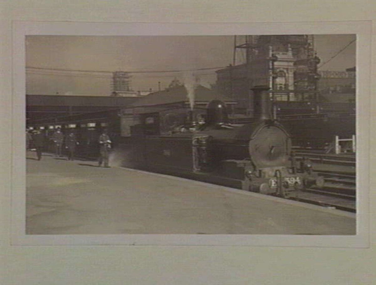 [Train at Flinders Street Railway Station] [Steam locomotive engine number E 394], Melbourne City (1909)
