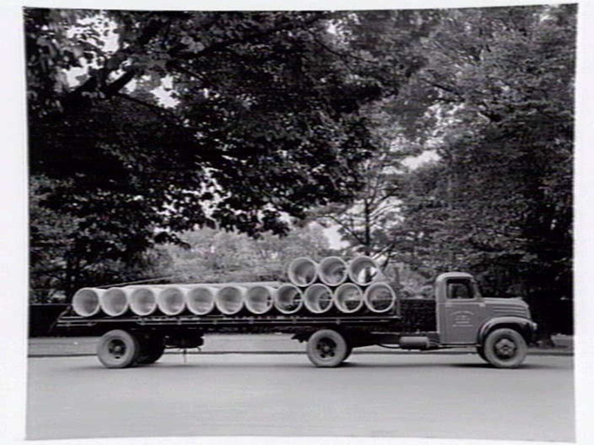 Truck from Humes Limited, 114 King Street, Melbourne, loaded with pipes, Melbourne City (1950?)