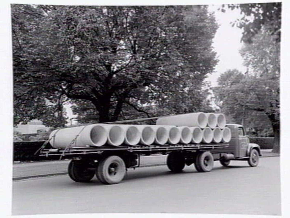 Truck from Humes Limited, 114 King Street, Melbourne, loaded with pipes, Melbourne City (c. 1950)
