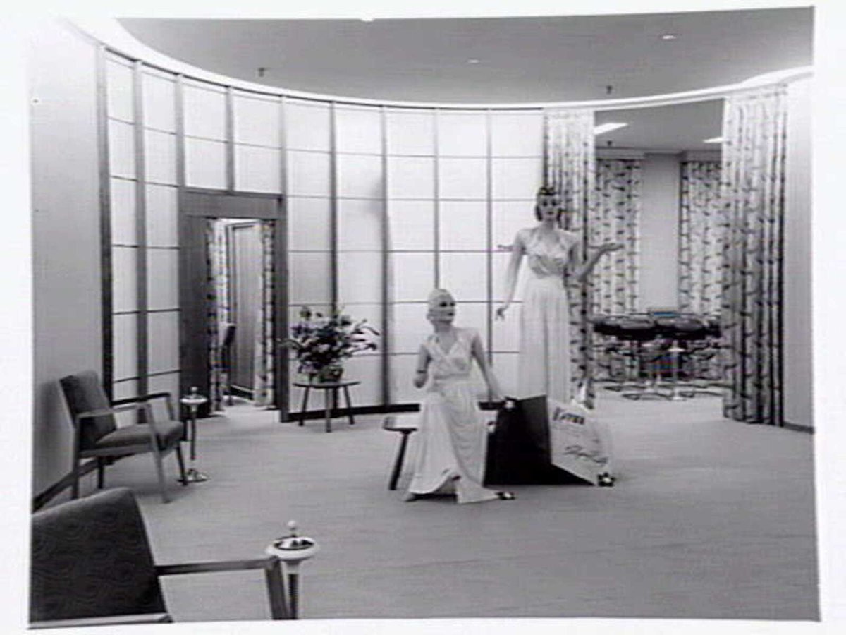 Julius Kayser & Co., 2nd floor, 328-42 Flinders Lane, Melbourne, showing small theatrette for mannequin displays, outer showroom area with display of Kayser sleeping gowns and office area, Melbourne City (1949)