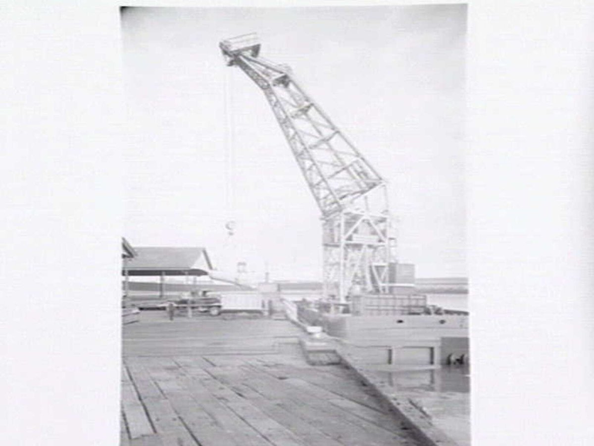 Melbourne Harbour Trust 40 ton floating crane lifting a boiler onto or from a low loader at wharf (1949)