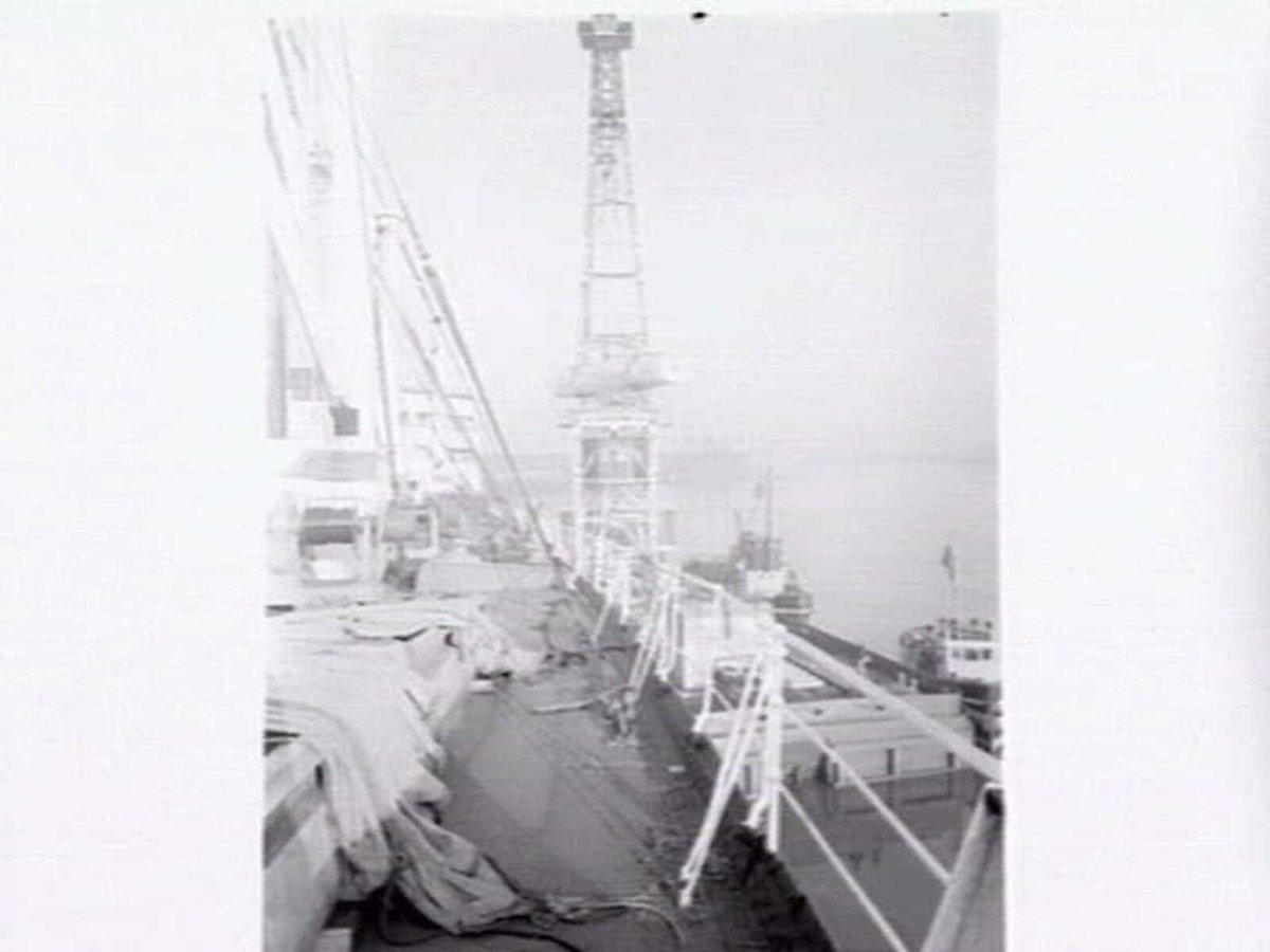 Melbourne Harbour Trust 40 ton floating crane lifting a boiler onto or from a low loader at wharf (1949)