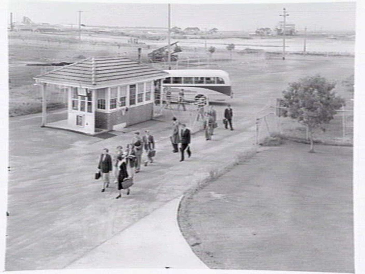 Monsanto Chemicals, Sommerville Rd., Braybrook, showing workers arriving by bus at front gate, plant and head office (1950)