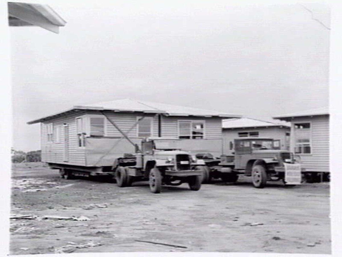 Housing Commission of Victoria pre-fabricated timber houses, showing construction in kitchen, bathroom and laundry, transfer of sections to building sites and positioning of houses on blocks at Sandringham Estate (1949)