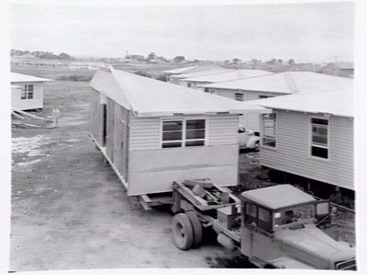 Housing Commission of Victoria pre-fabricated timber houses, showing construction in kitchen, bathroom and laundry, transfer of sections to building sites and positioning of houses on blocks at Sandringham Estate (1949)
