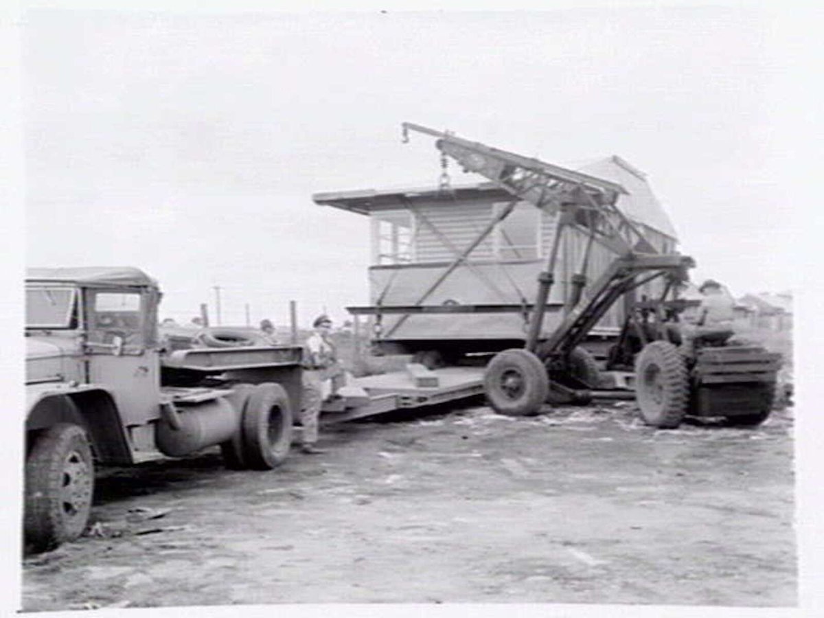 Housing Commission of Victoria pre-fabricated timber houses, showing construction in kitchen, bathroom and laundry, transfer of sections to building sites and positioning of houses on blocks at Sandringham Estate (1949)