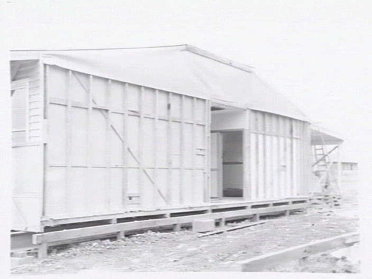 Housing Commission of Victoria pre-fabricated timber houses, showing construction in kitchen, bathroom and laundry, transfer of sections to building sites and positioning of houses on blocks at Sandringham Estate (1949)