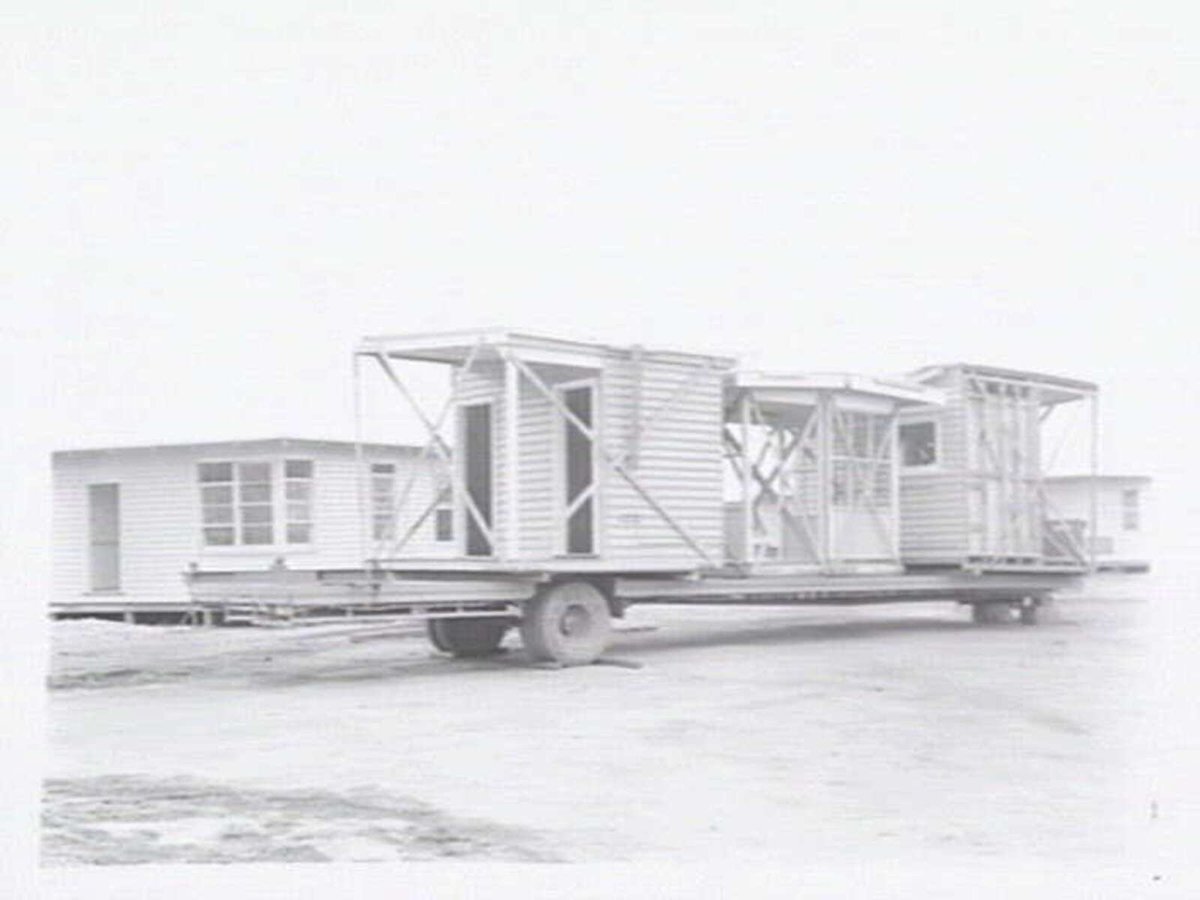 Housing Commission of Victoria pre-fabricated timber houses, showing construction in kitchen, bathroom and laundry, transfer of sections to building sites and positioning of houses on blocks at Sandringham Estate (1949)