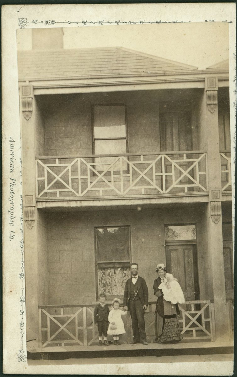 Unidentified family standing in front of a double storey terrace house, Capel Street, West Melbourne (1882–84)