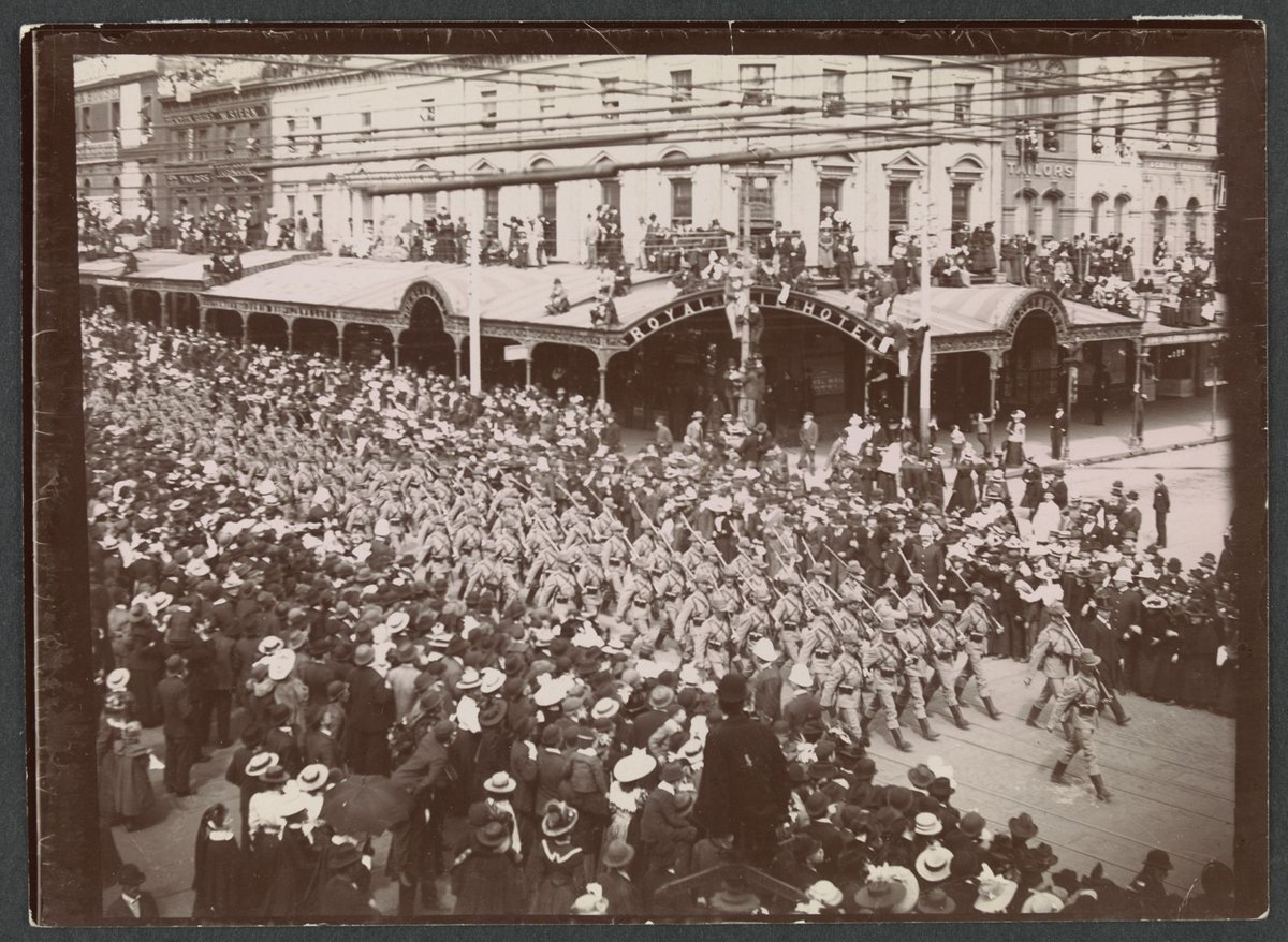 Victorian army contingent, Second Boer War, marching past Royal Mail Hotel, corner Swanston and Bourke streets, Melbourne, Melbourne City (c. 1900)