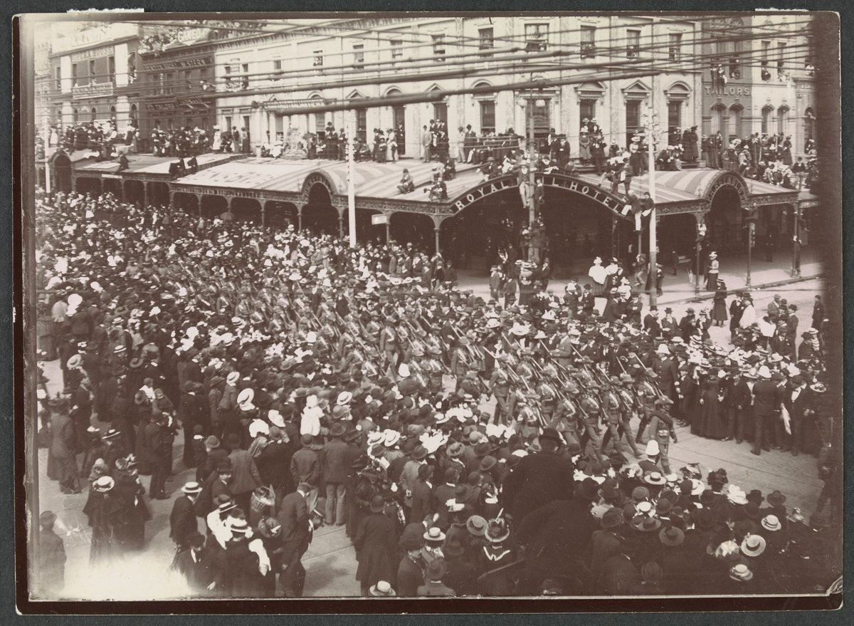 Victorian army contingent, Second Boer War, marching past Royal Mail Hotel, corner Swanston and Bourke streets, Melbourne, Melbourne City (c. 1900)