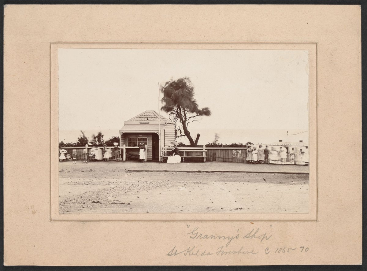 Granny's Shop on the Esplanade, St. Kilda. Royal Ladies Baths in the background, St Kilda (c. 1870)