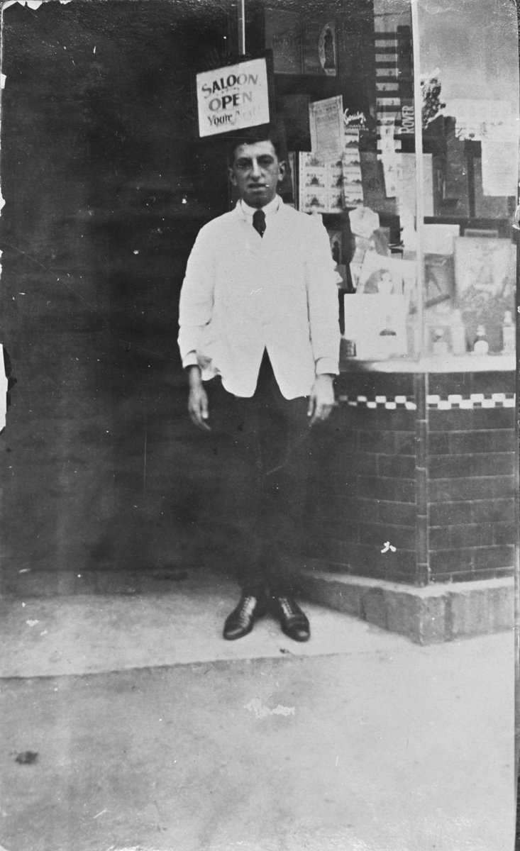 George Batrouney outside his barbers shop, Exhibition Street, Melbourne, in the late 1920s, Melbourne City