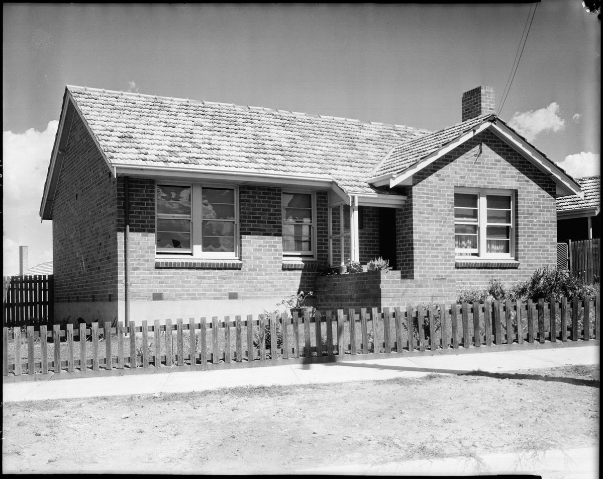 Housing Commission home with a front fence of un-painted timber pickets, Coburg, Preston and Heidelberg area (c. 1947)
