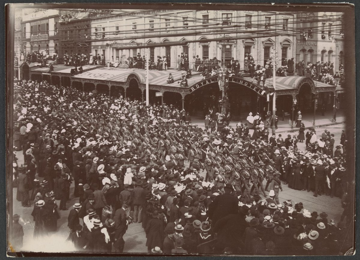 Victorian army contingent, Second Boer War, marching past Royal Mail Hotel, corner Swanston and Bourke streets, Melbourne, Melbourne City (c. 1900)