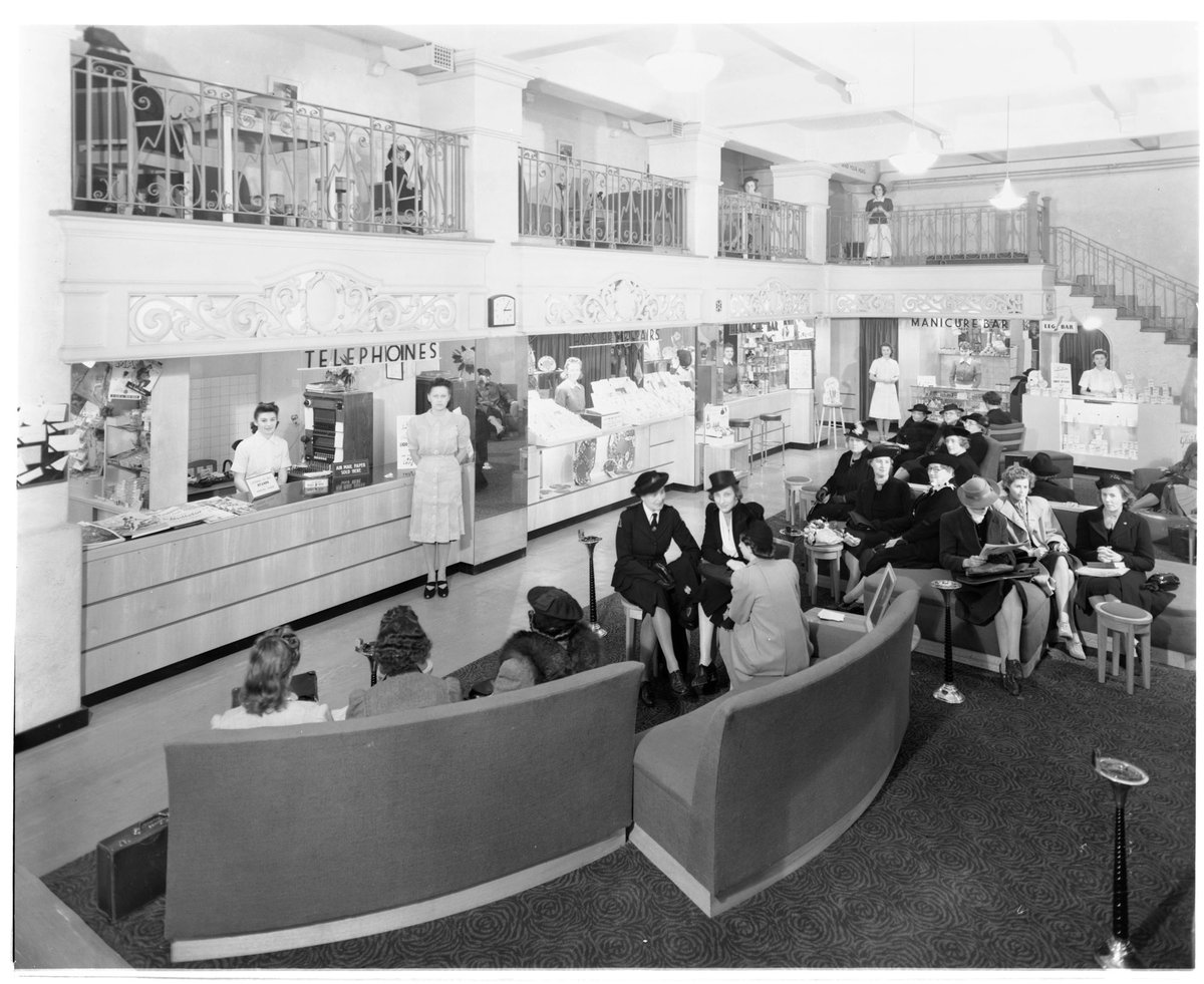 My Lady's Rest Lounge, 182 Collins Street, showing waiting area, Leg bar, Manicure bar, Hosiery repair counter, with attendants and customers, Melbourne City (c. 1941)