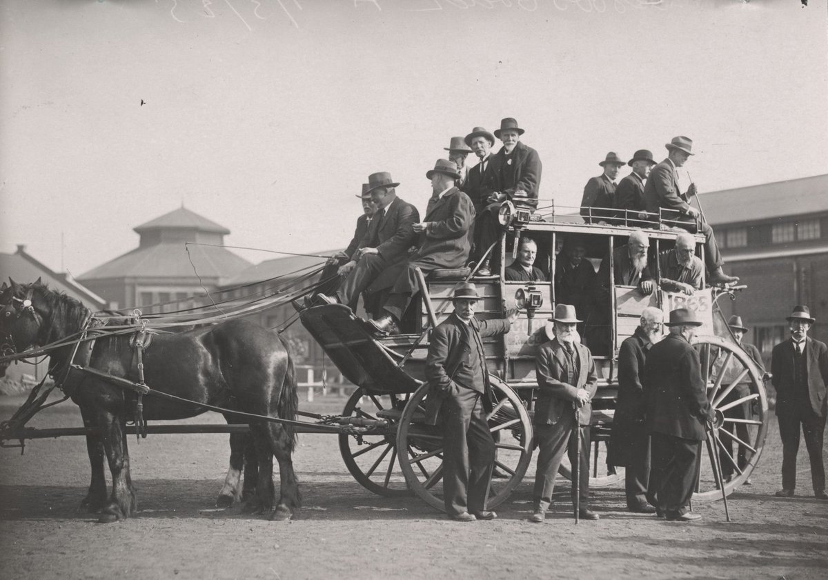 An old time Cobb & Co. Coach held at the International Motor Show, Exhibition Buildings, Melbourne. The driver is Frank Smiley driving his colleagues through the city streets, Carlton (1925)