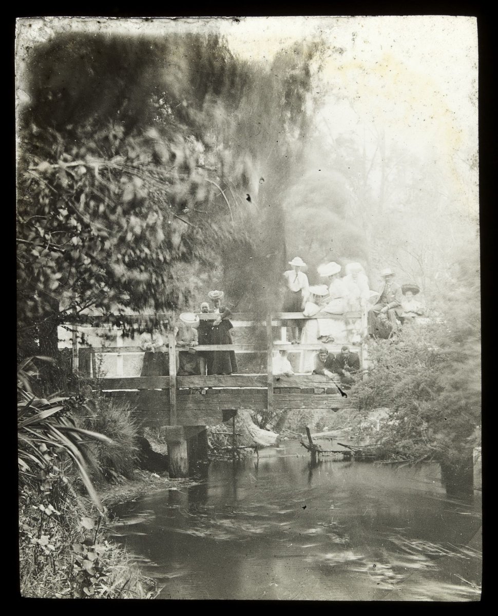 Sightseers on wooden bridge looking at Yarra river (1909)
