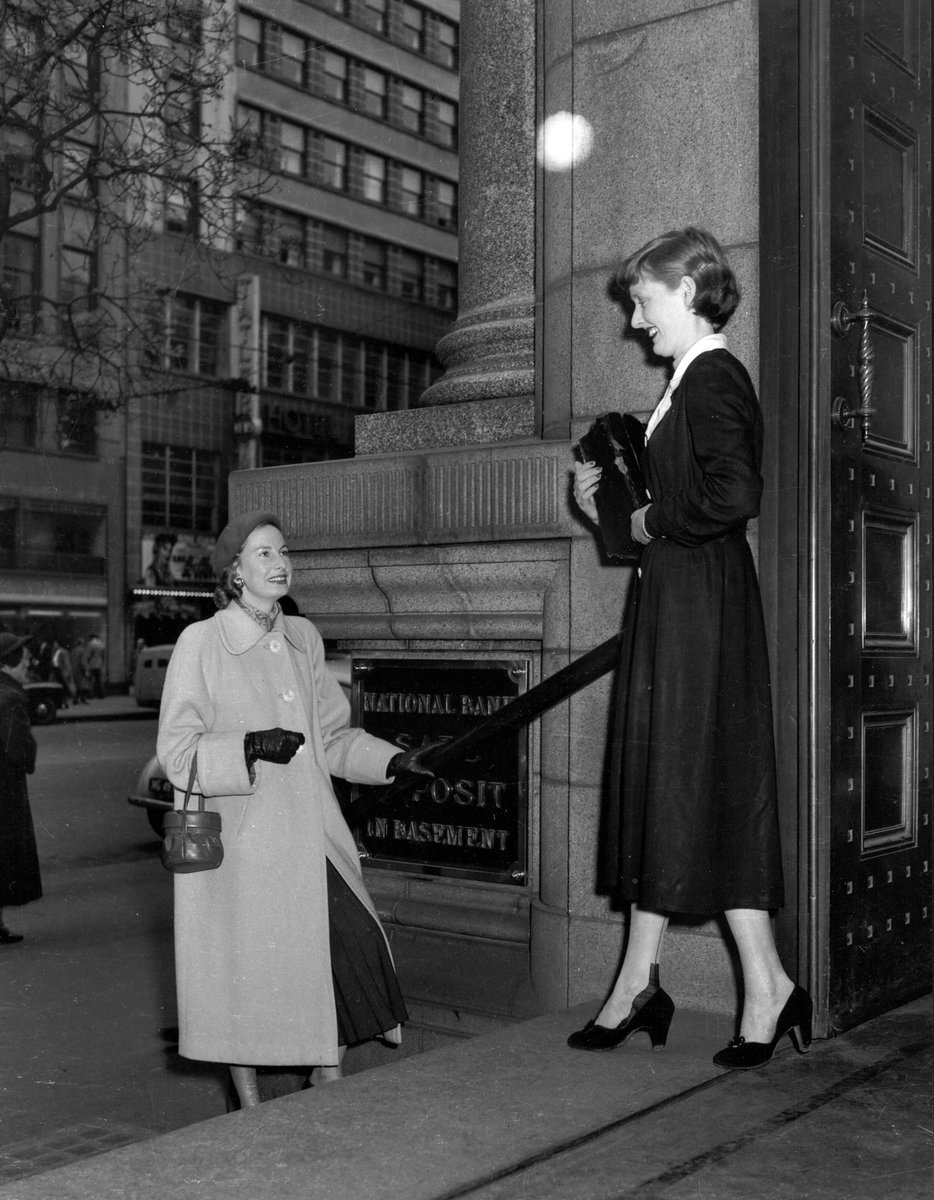 Female bank clerk and another woman on entrance steps National Bank of Australasia State Head office 279 Collins Street Melbourne, Melbourne City (1953)
