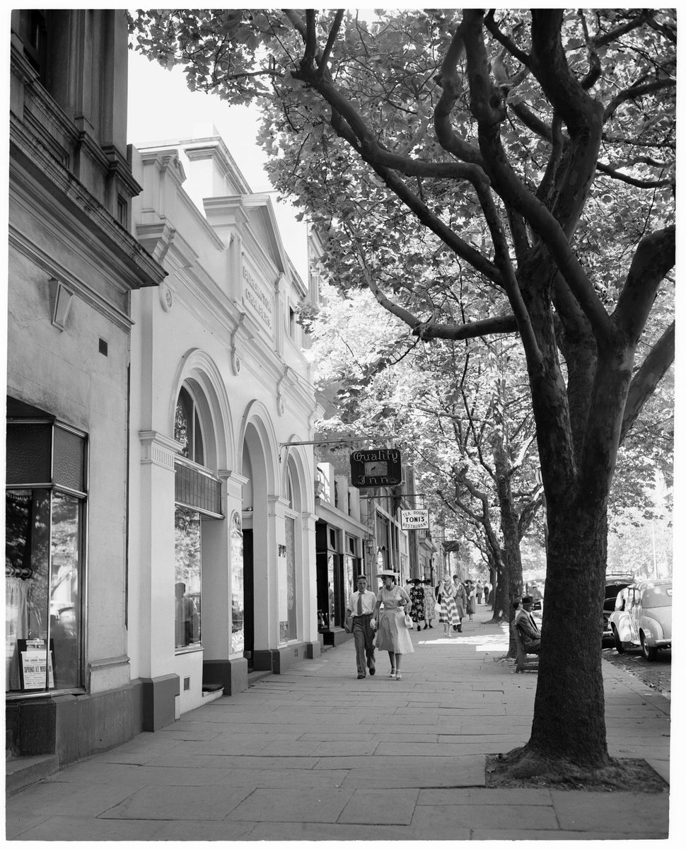 Quality Inn and Toni's Tea Rooms on the shady footpath of Collins Street, Melbourne City (1954)