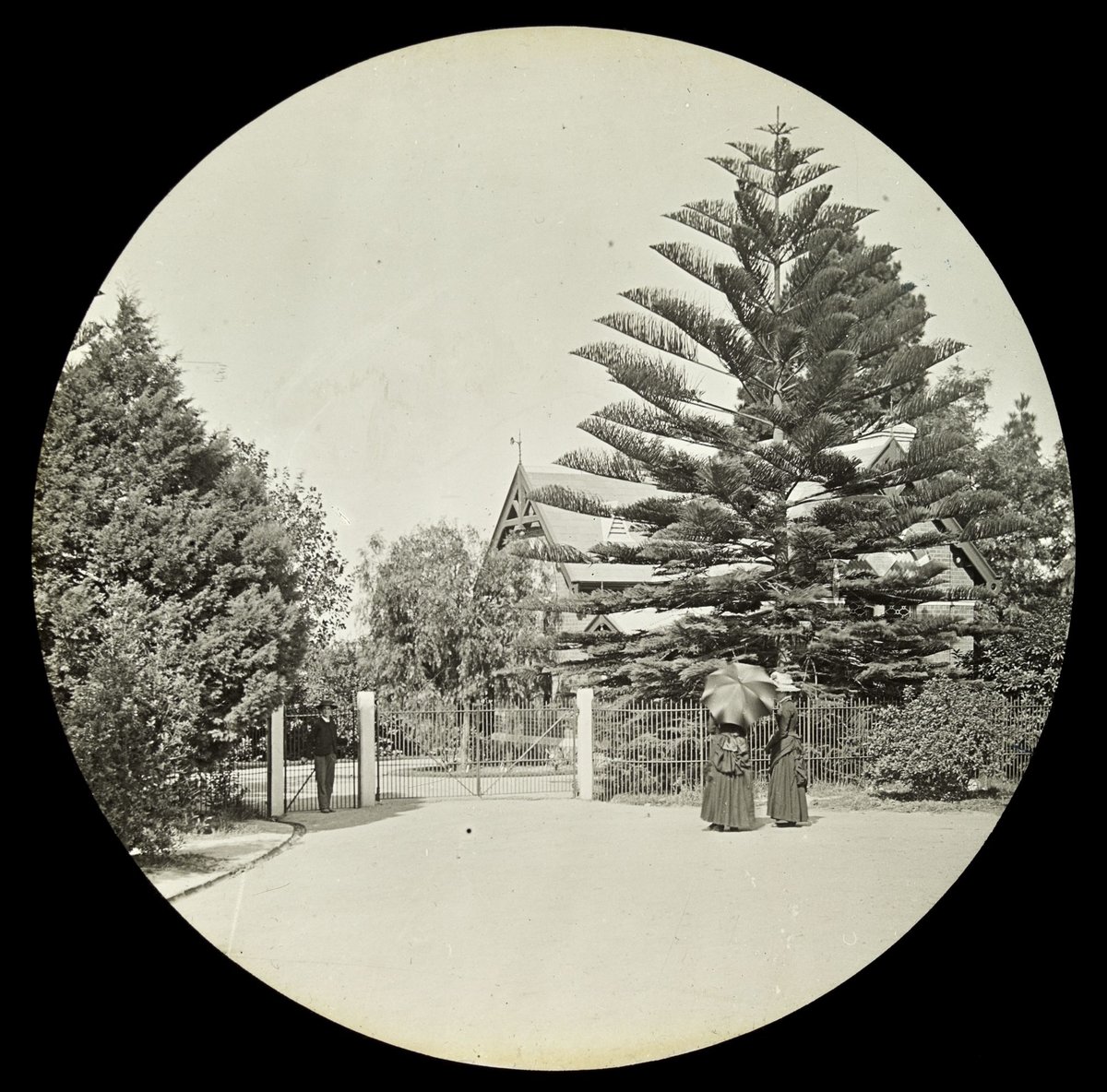 Man and two women standing at the entrance to the Botanical Gardens, Melbourne, Victoria, Melbourne City (1890–1901)