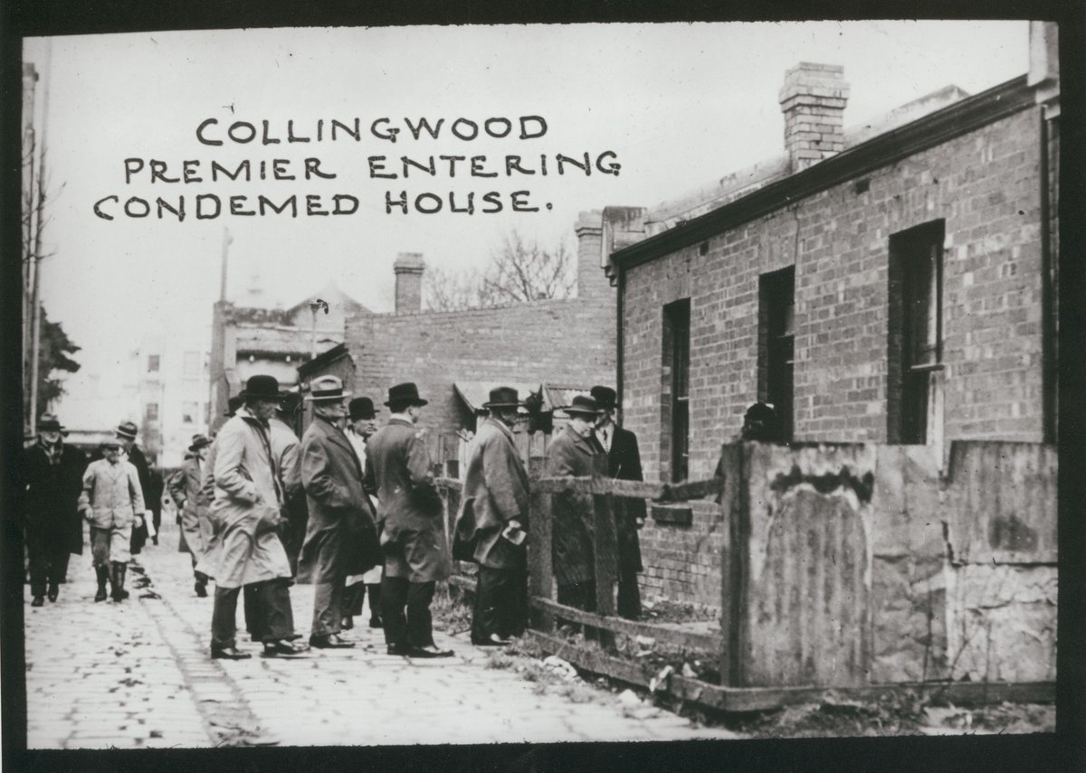 Collingwood. Premier entering condemed [i.e. condemned] house (c. 1935)