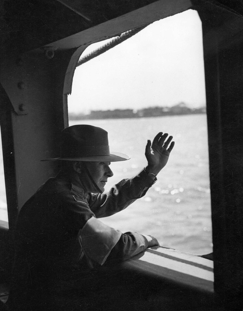A.I.F. embarkation from Port Melbourne "I", serviceman silhouetted against the midday sun waving goodbye through ship's window (c. 1941)