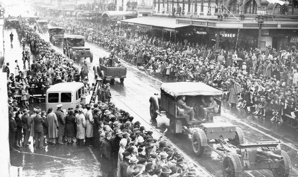 Looking up Swanston Street from Collins Street at cavalry (?) or artillery units during Empire Day drive for recruits, Melbourne City (c. 1941)
