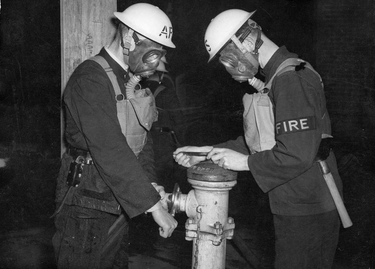 Mr. A. L. Higgs & Senior Fireman E. J. Goodwin linking up street hydrant Malvern A.F.S. [i.e. Auxiliary Fire Service] (c. 1942)
