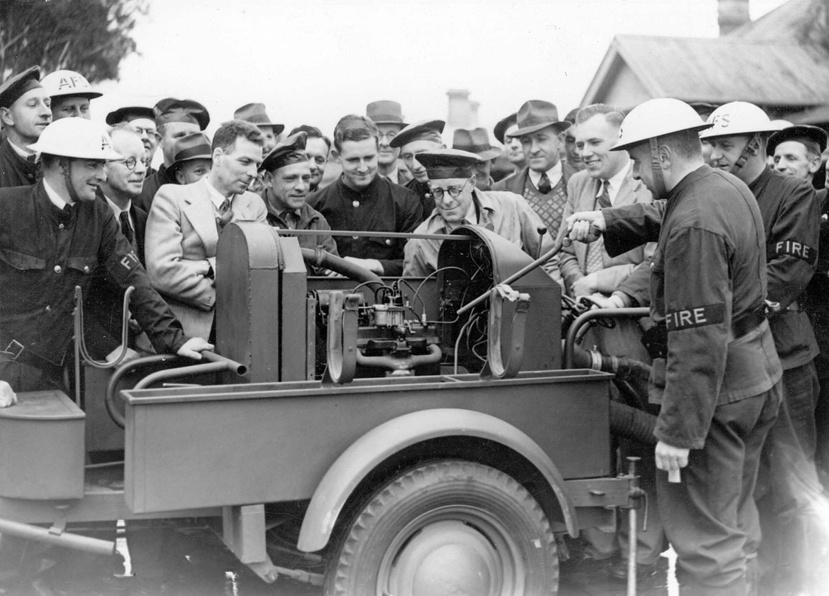Mr. V. L. Solomons instructing members of the Brighton A.F.S. [i.e. Auxiliary Fire Service] on the workings of the mobile trailer pump (c. 1942)