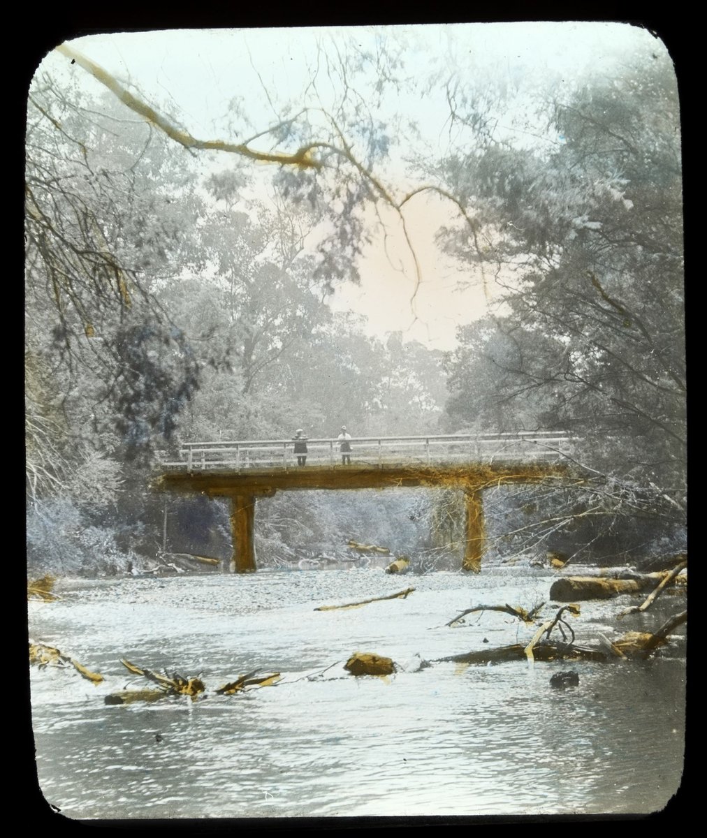 Two men standing on wooden bridge over the Yarra River in country Victoria (1909)