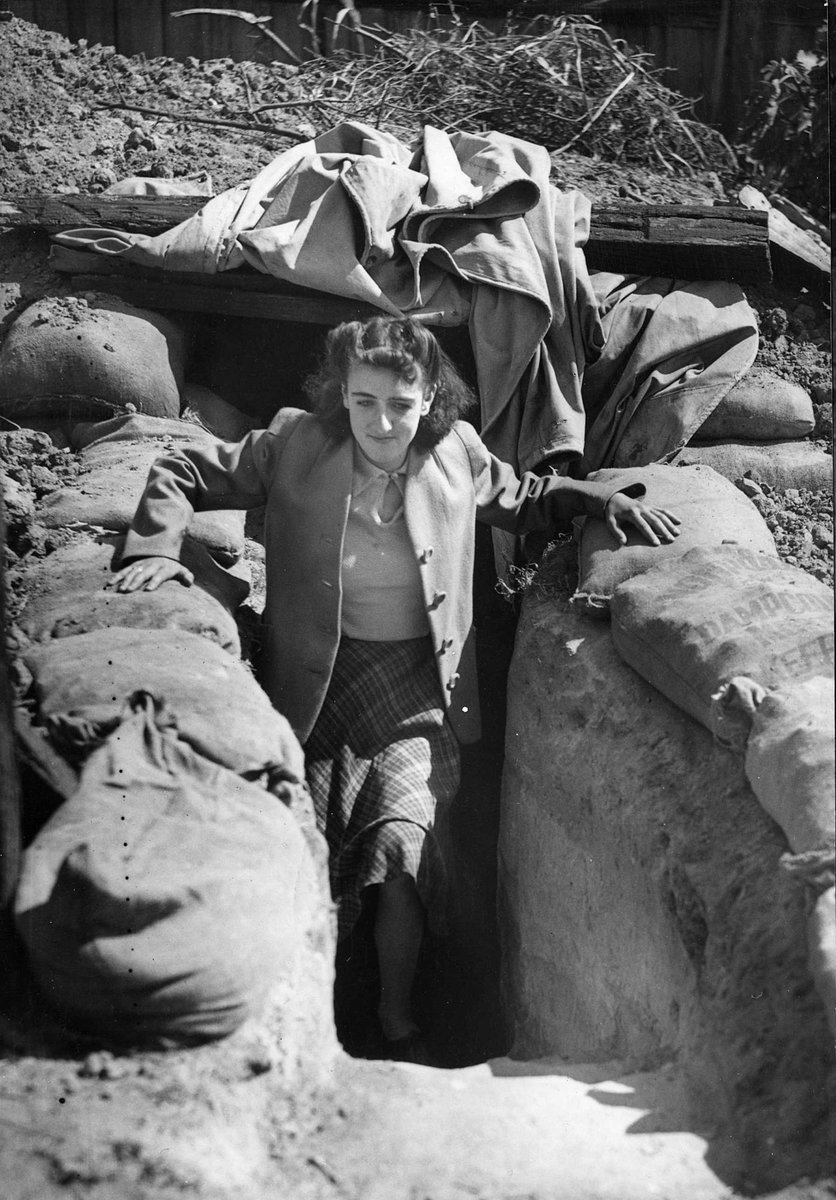 Woman leaving an under-ground shelter, West Brunswick, Melbourne, Brunswick West (c. 1941)