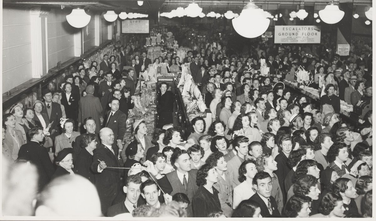 Interior crowd men and women in store for a manequin parade (models out of picture) Bourke Street Store No. 12, Melbourne City (1952)