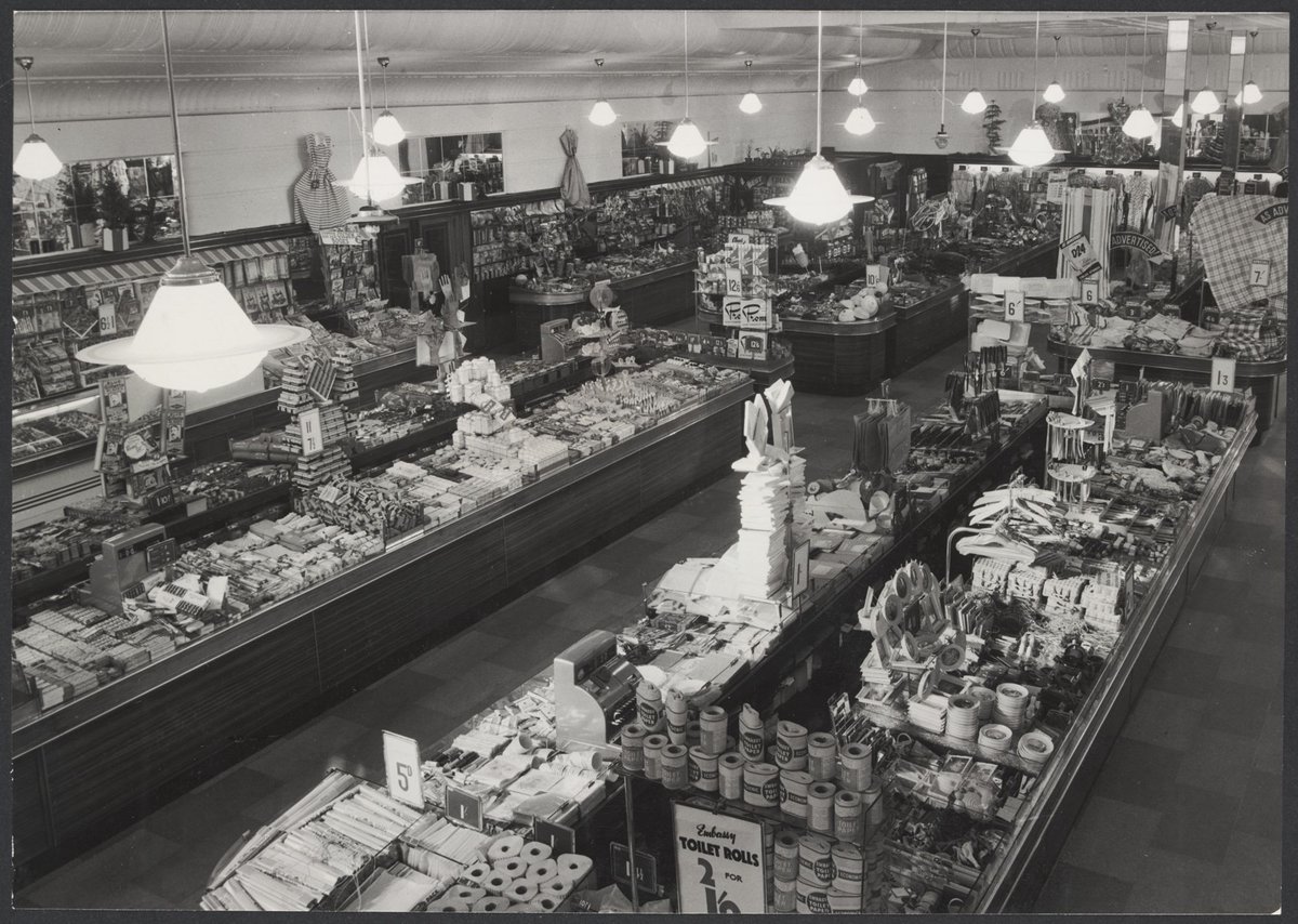 Interior of Coles store St. Kilda showing counters of merchandise including toilet paper, St Kilda (1954)