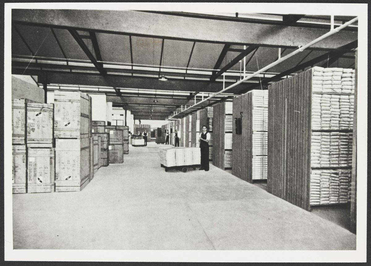 Merchandise Department section of Melbourne warehouse shows shelving and staff (1930s)