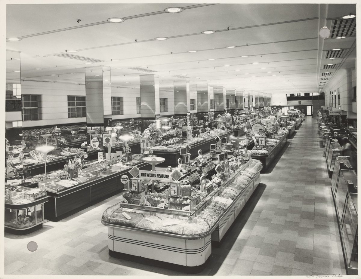 Interior ground floor showing tables of merchandise 'This week's feature' barley sugar on display in Bourke Street Store No. 12, Melbourne City (1940s)