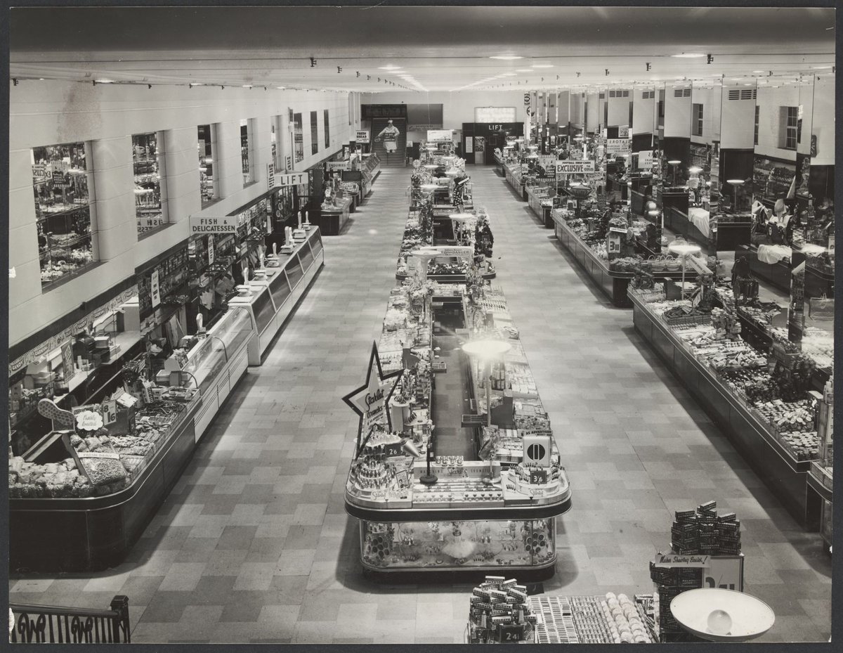 Interior of Coles store Bourke Street showing counters with merchandise on display including Colgate toothpaste for 2/4'd Store No.12, Melbourne City (1954)