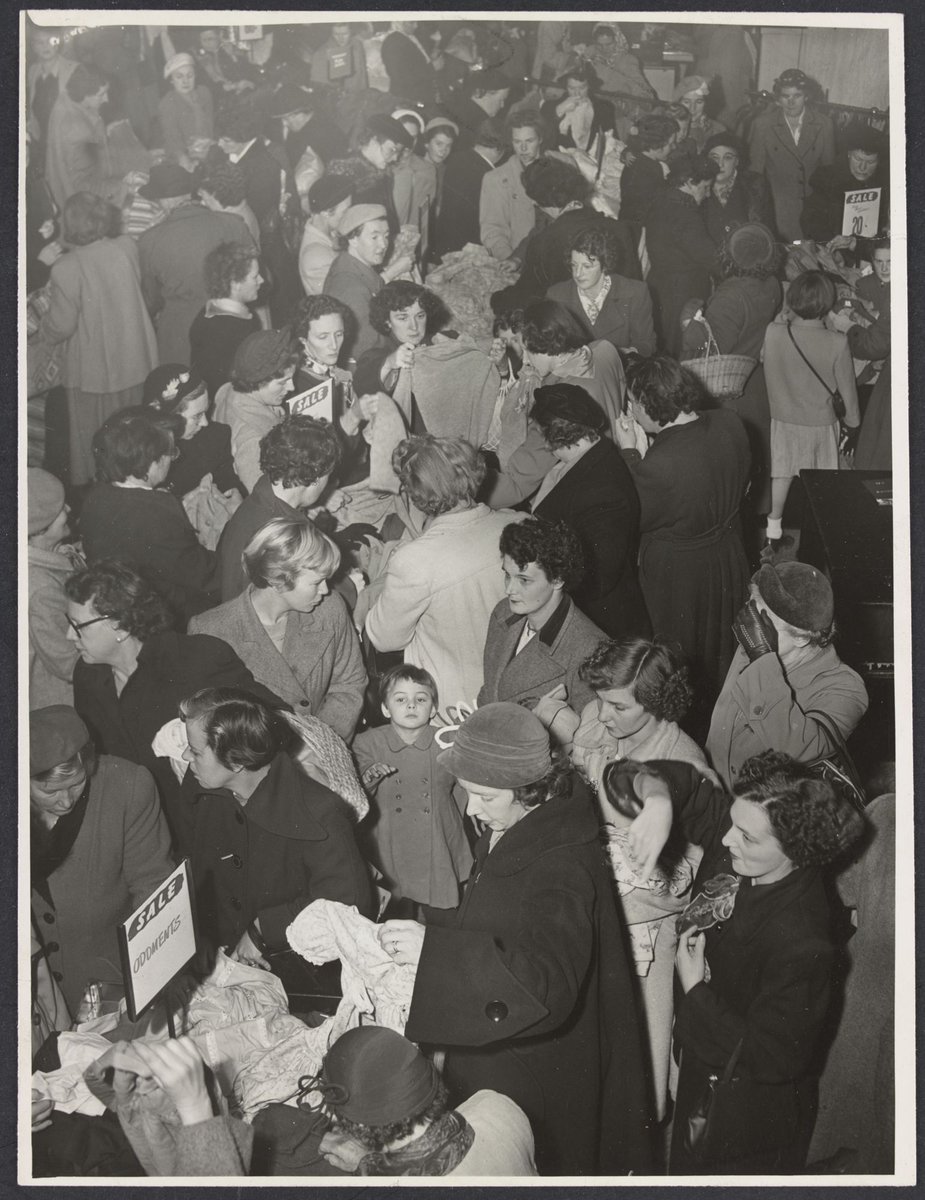 Large crowd of shoppers in store rummaging through sale items in Mantons Bourke Street, Melbourne City (1942–51)