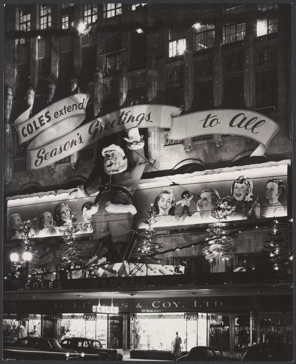 Exterior view of Coles store in Bourke Street Melbourne displaying a big Santa Claus 25' high with a waving left arm Store No. 12, Melbourne City (1954)