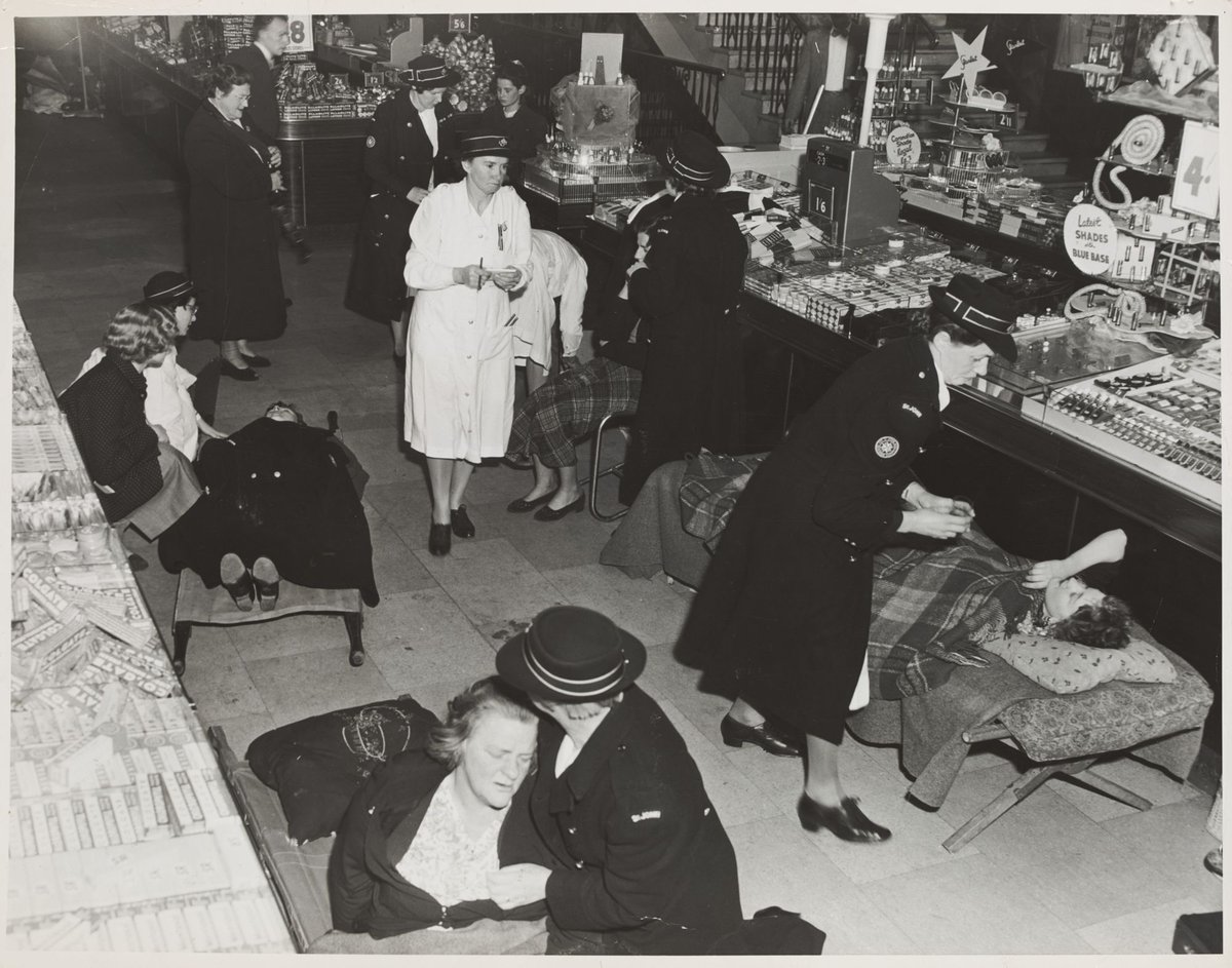 St. John Ambulance women giving first aid to people hurt in crush coronation of Elizabeth II Bourke Street Store No. 12, Melbourne City (1953)