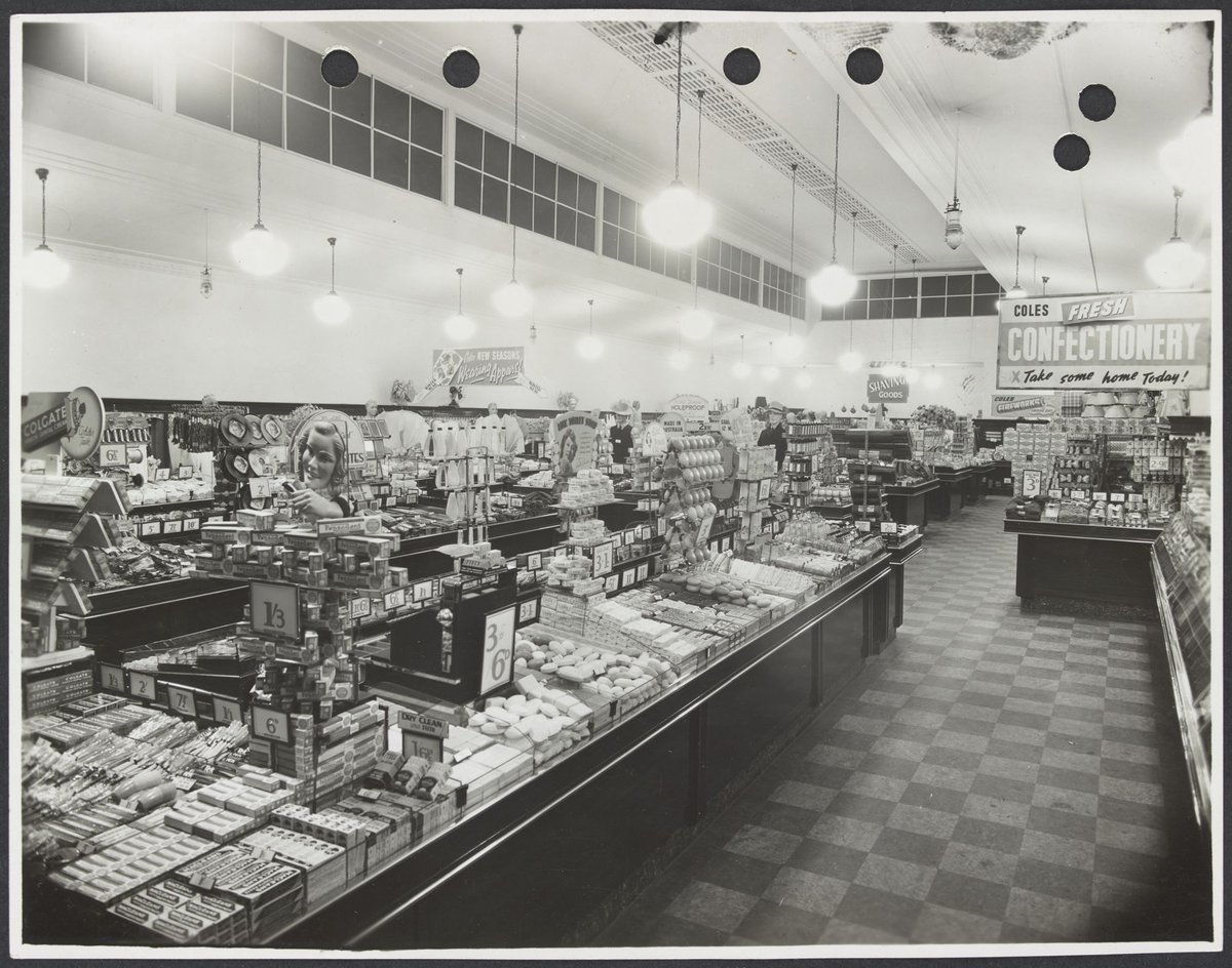 Elevated view of interior showing display counters of toiletries and advertising for confectionery in Coles Collingwood Store No. 1 (1936)